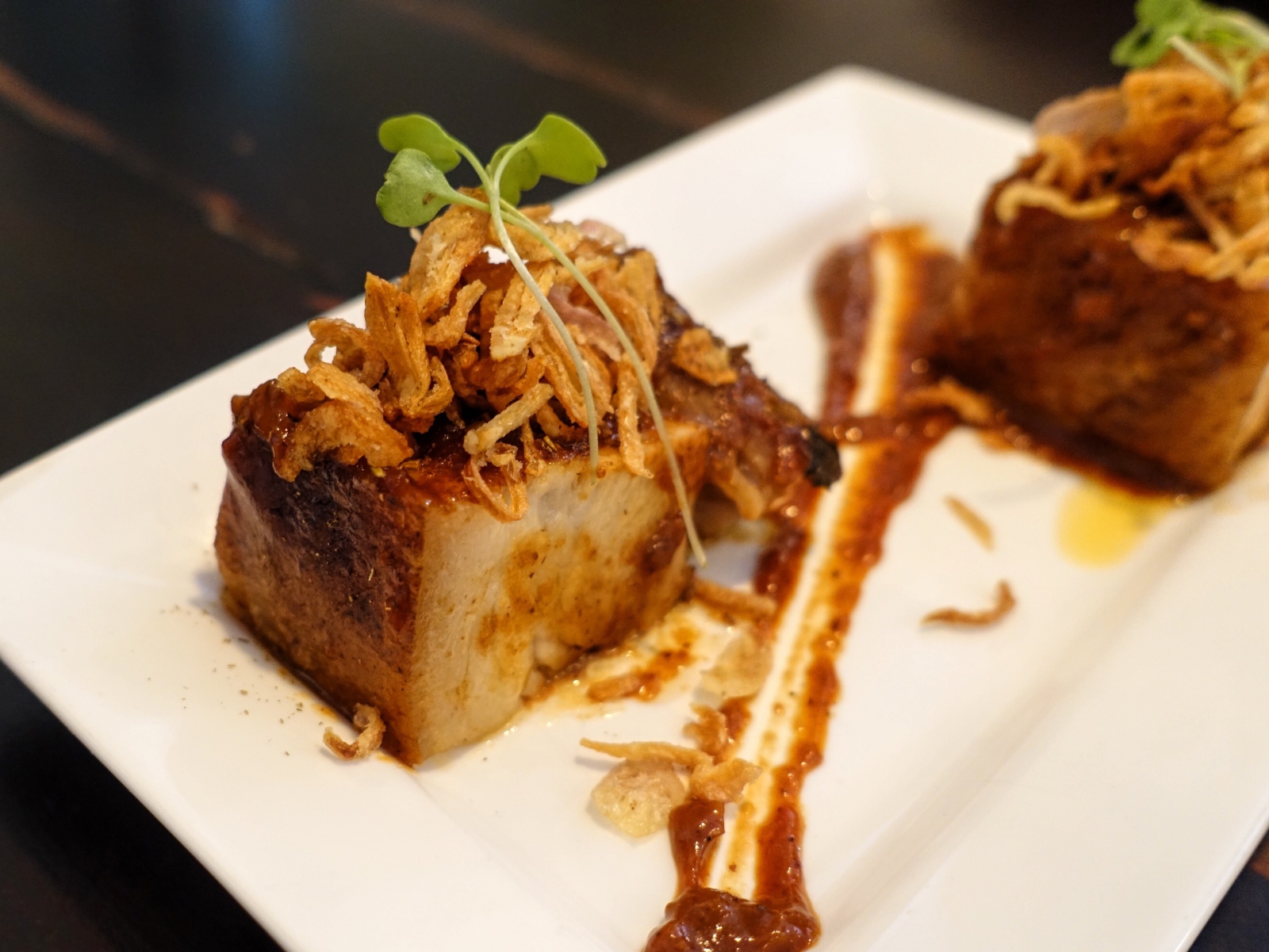 Pork belly with crispy shallots, fennel, and sweet chipotle at Condesa in London